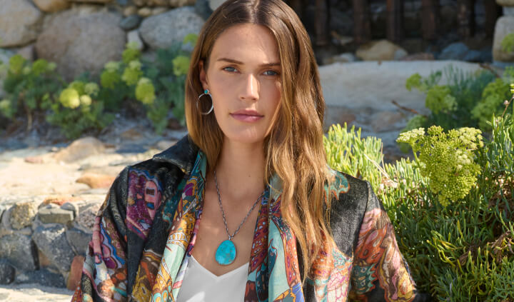 Model wearing turquoise earrings and necklace