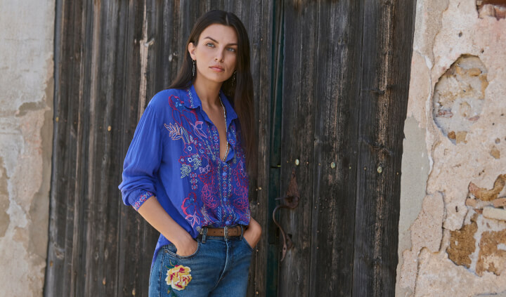 Model wearing embroidered blue button down