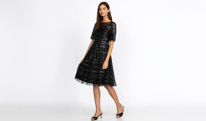 Model wearing a black sequined mesh dress