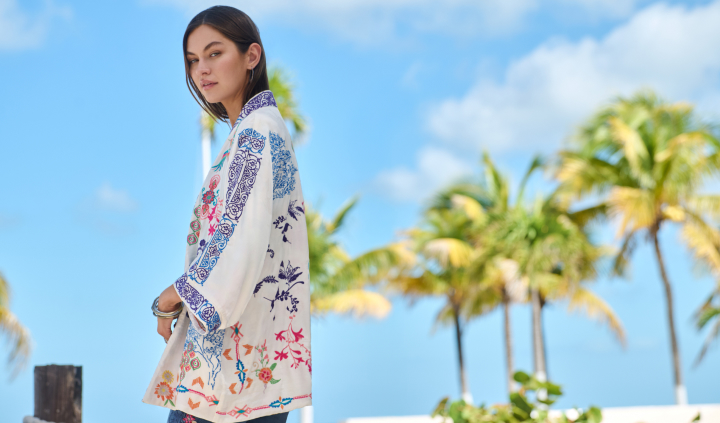 Model wearing a white and blue embroidered kimono