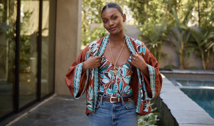 Model wearing printed silk kimono and cami with jeans