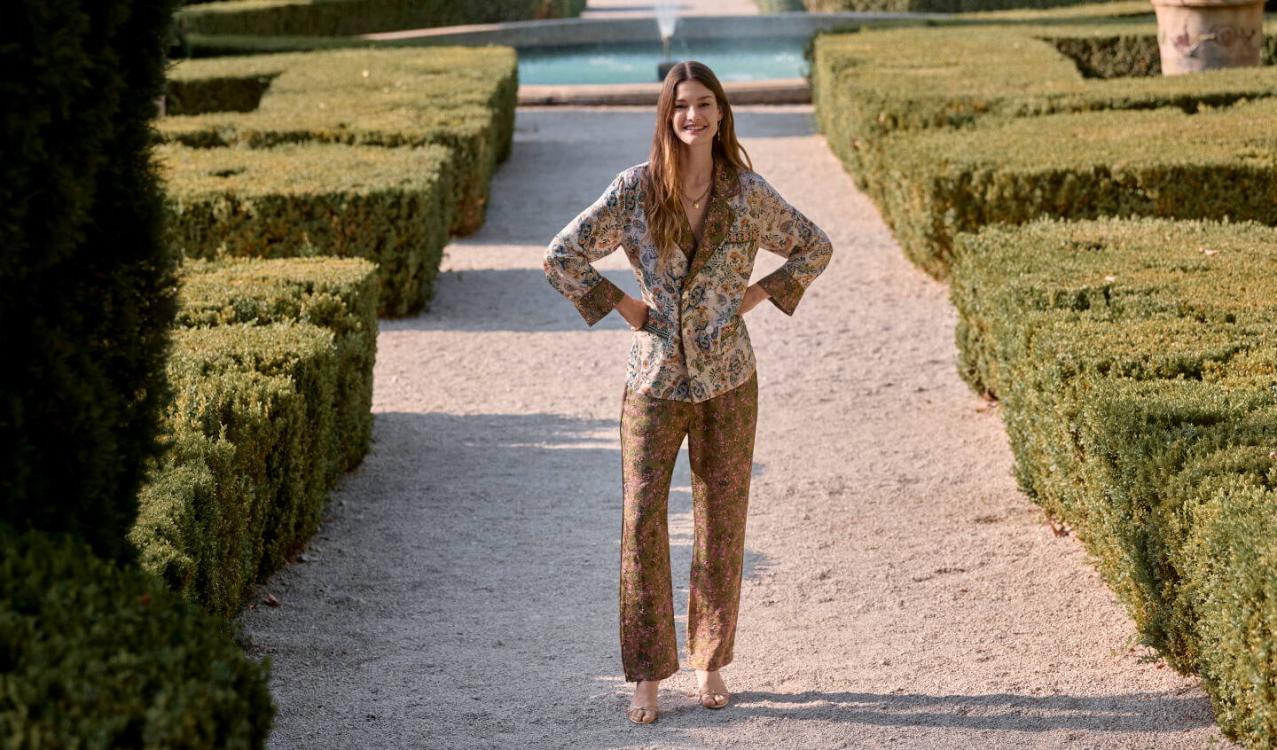 Model standing in printed blazer and pants